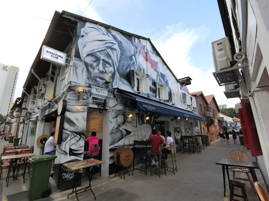 Street Art in Kampong Glam: A bold black and white portrait covering two storeys on the side of a row of shophouses by Ceno2.