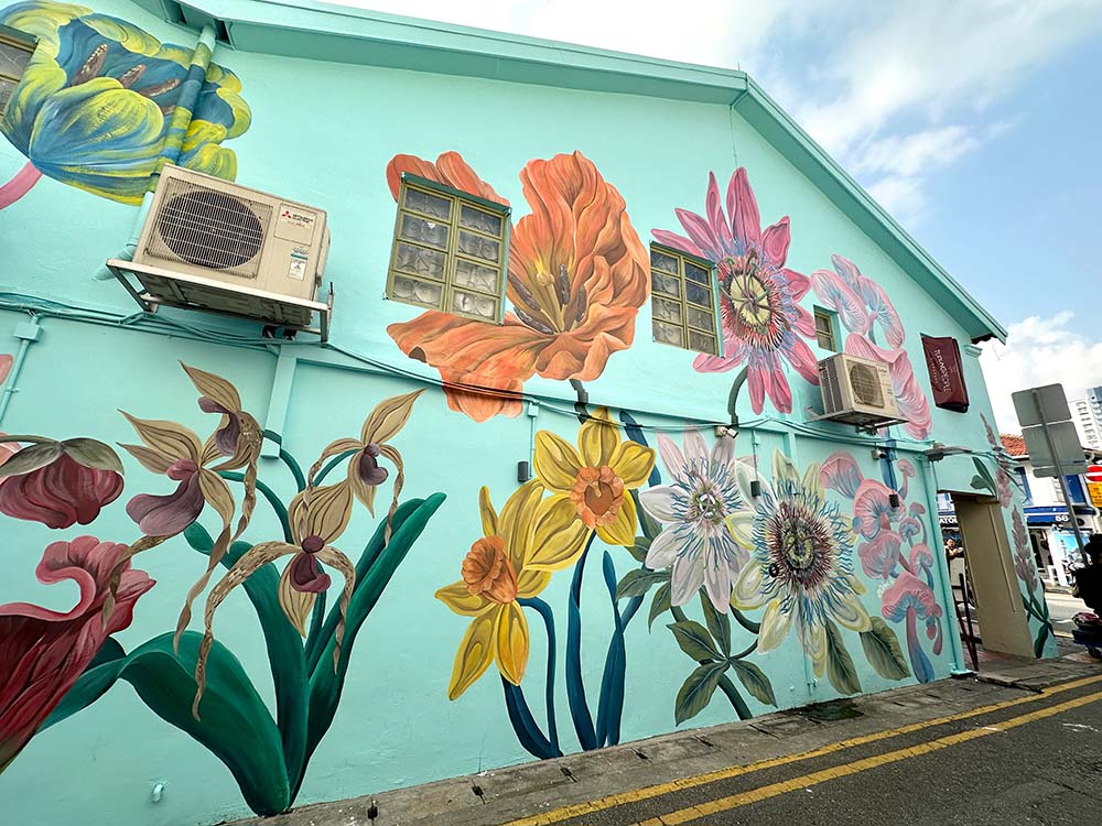 Mural on a blue wall featuring colourful flowers