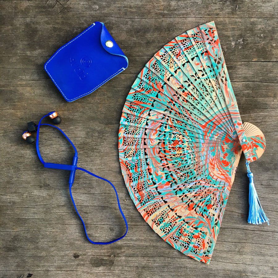 Flatlay of the Sudio Vasa Bla Earphones, leather carrying case and my pretty decorative fan