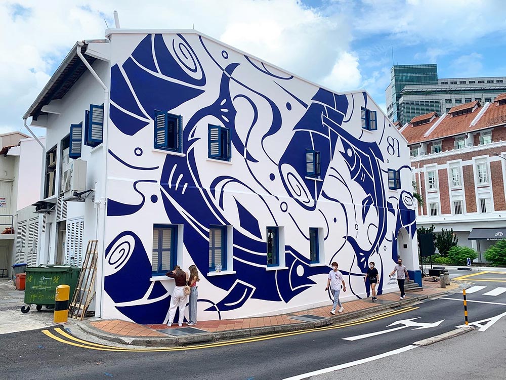 Ikan Todak is a mural by Tobyato, a large white wall of a shophouse covered with dark blue swordfish and banana tree stems