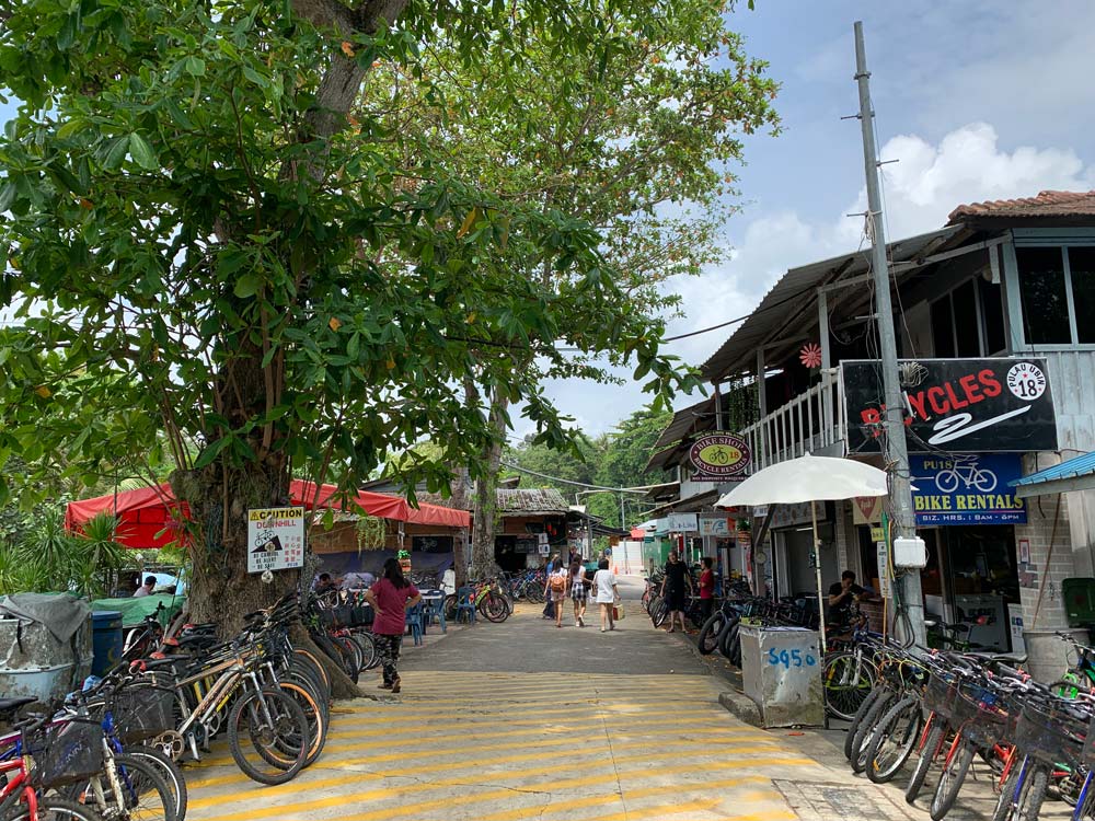 Bicycles line the road as you leave the jetty, ready for rental