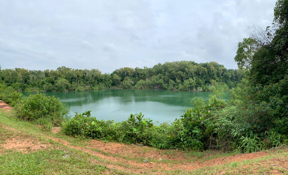 The emerald-green Balai Quarry lake surrounded by trees