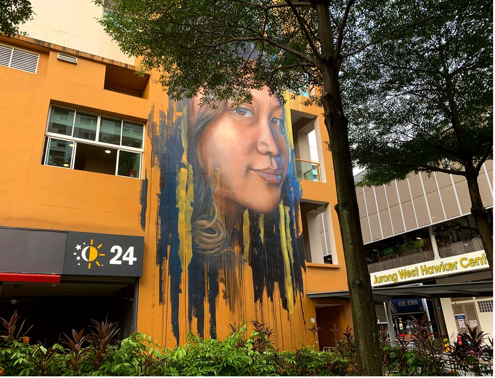 AdNate painted a larger-than-life portrait of a Singaporean girl on the side of Pioneer Mall