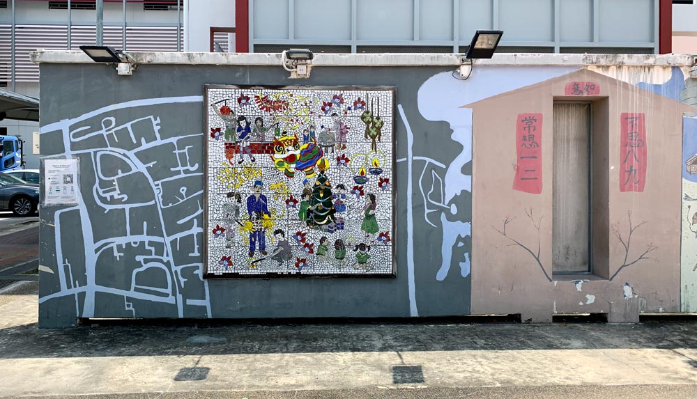 This wall has what looks like a rough map of the streets of Taman Jurong, a mosaic of multi-ethnic activities and something that looks like a Chinese shrine?