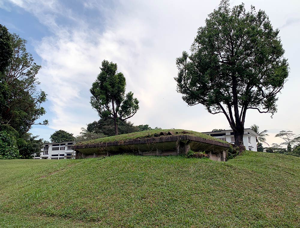 Half-buried pillboxes in Sembawang are a remnant of World War II 