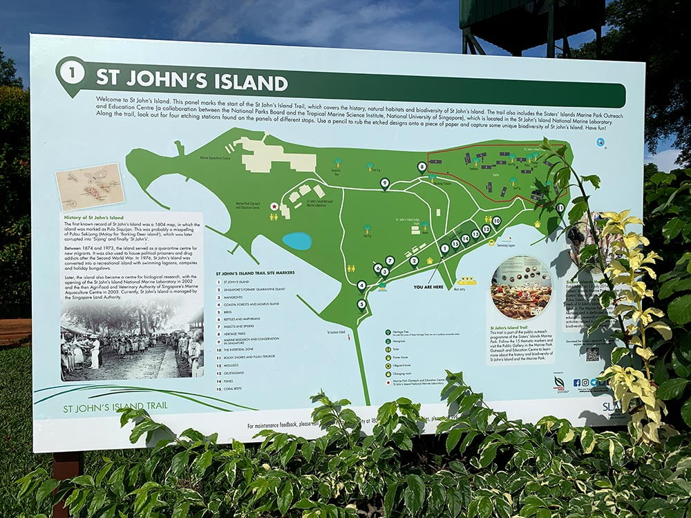 Large signboard of map of St John's Island with the island's highlights marked out and a short description of the history of the island. 