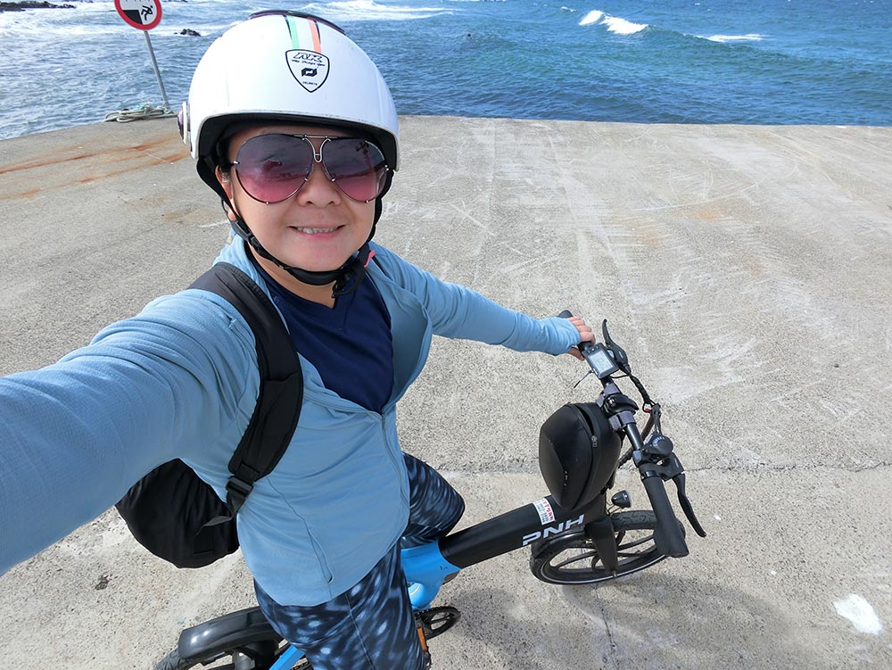 Selfie of me in blue with my blue bicycle on Udo