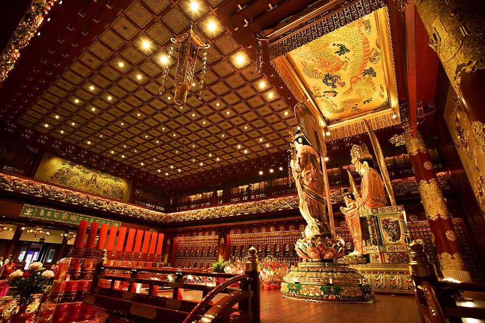 Intricately decorated hall with Buddhist statues